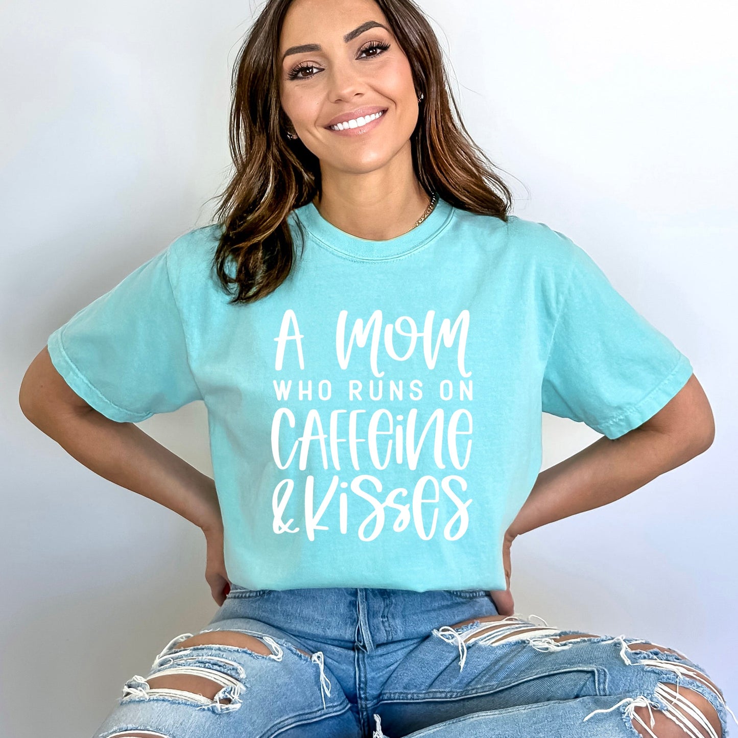 A Mom Who Runs On Caffeine And Kisses | Garment Dyed Short Sleeve Tee